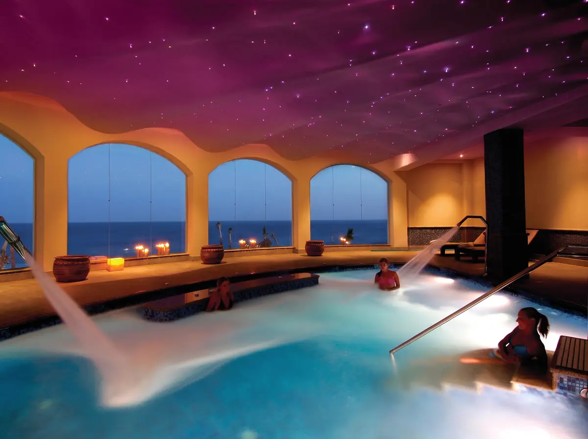 Blue Bay Resort Thalassotherapy Spa – Hydrotherapy pool with water jets under a star-lit ceiling and arched sea windows