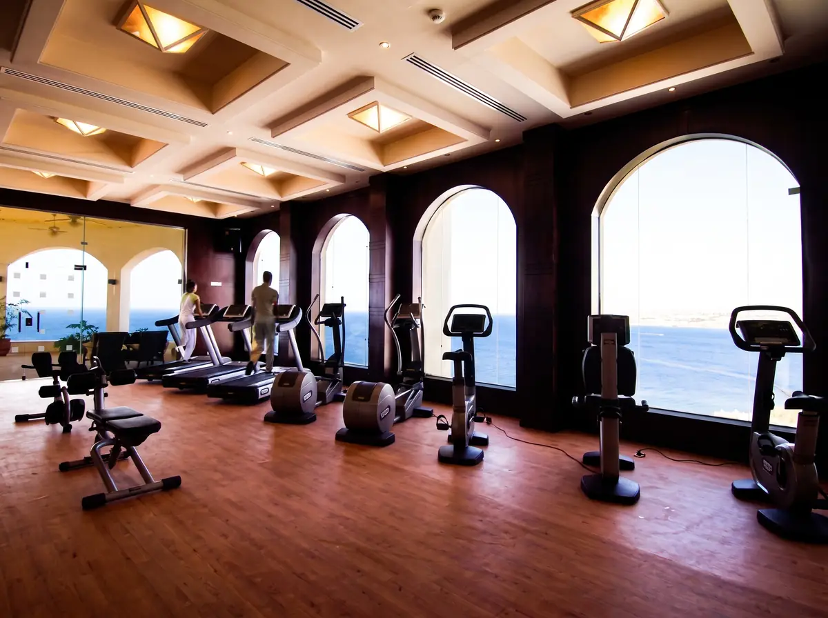 Blue Bay Resort Thalassotherapy Spa – Fitness room with cardio machines and tall arched windows over the Red Sea