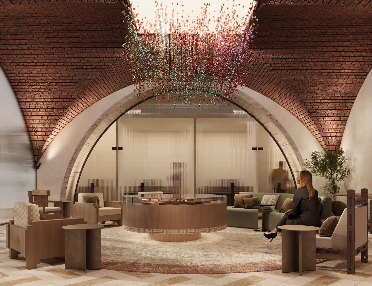Citadel Plaza Sales Office – Round desk, sofa and lounge chairs set before a fluted-glass arch
