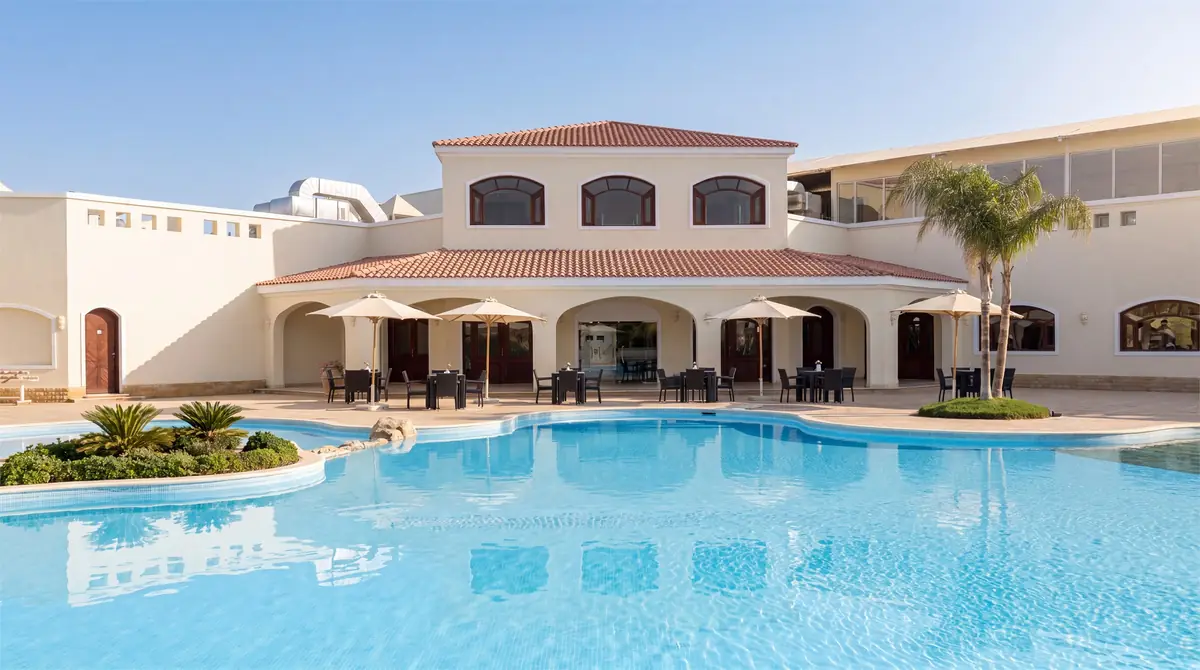 Green Heights Compound – Clubhouse with arcaded terrace, parasols and a freeform pool