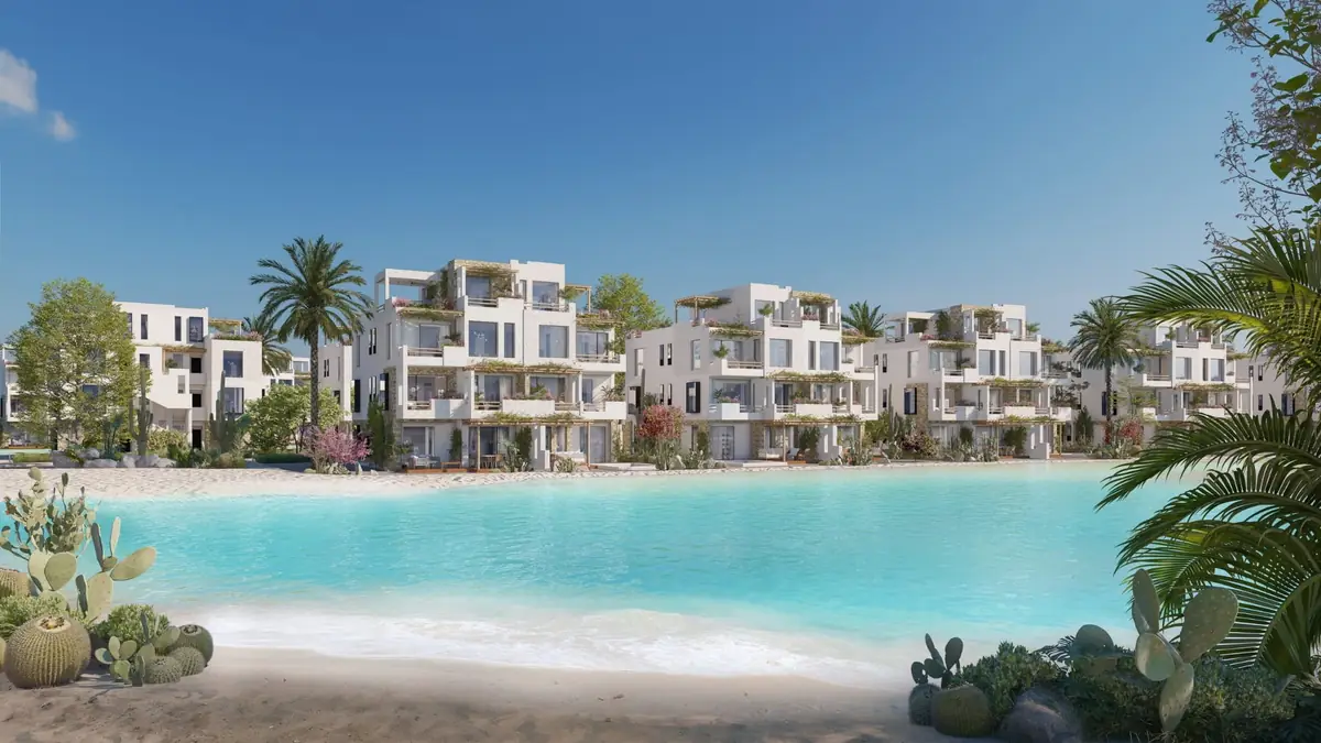 Masyaf Ras Al-Hekma – Turquoise lagoon beach lined with white terraced homes, palms and cacti