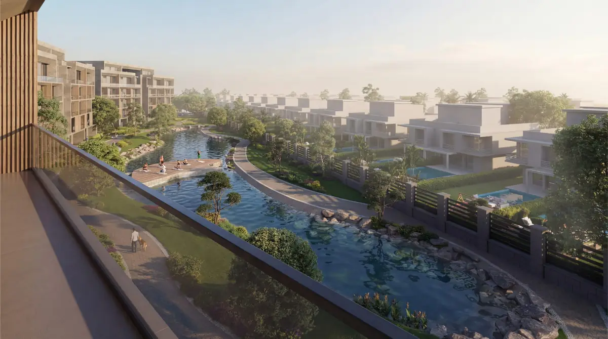 Mist – Balcony view over a winding lake bordered by gardens and townhouses