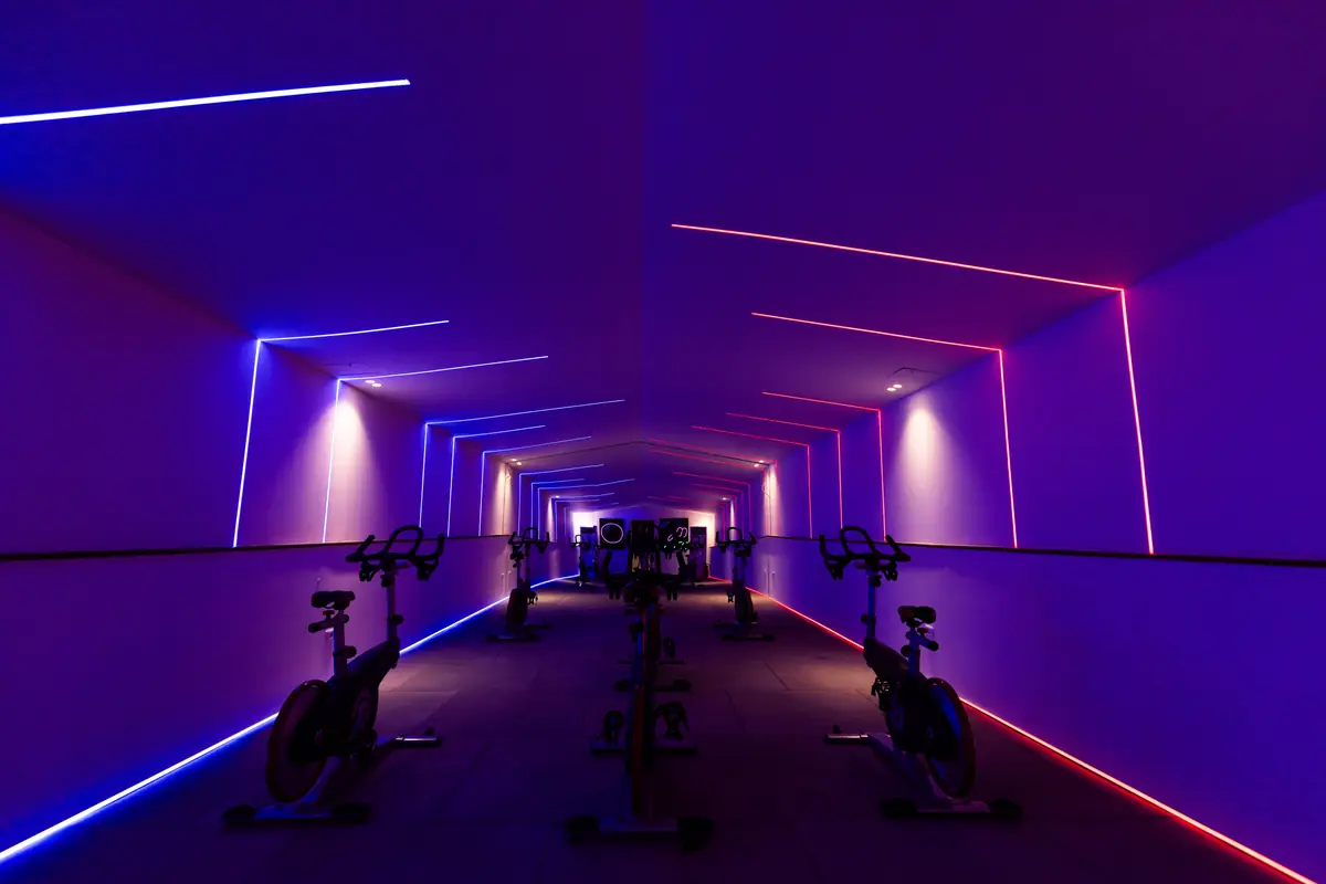 Move – Green Heights Sports Complex – Dark neon tunnel of the spinning studio seen head-on