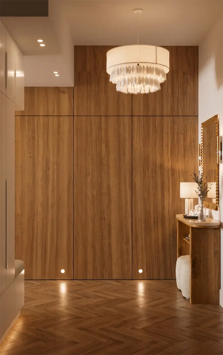 Mrs. A.'s Apartment – SODIC – Warm honey-oak entrance wall with floor spotlights and a fringed pendant