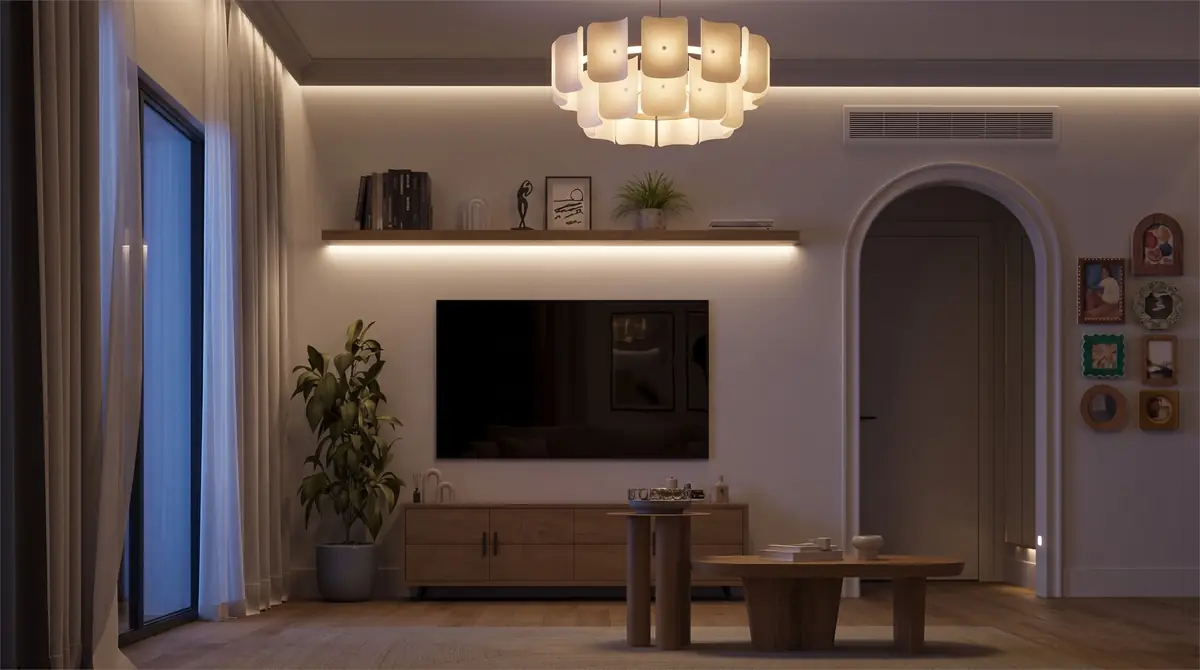 Mrs. A.'s Apartment – SODIC – TV wall and arched doorway at night, lit by the pendant and shelf strip