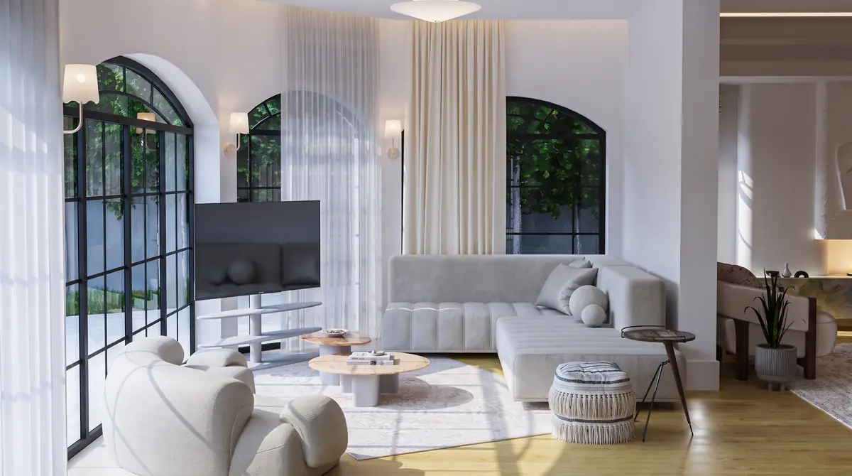 Mrs. S.T.'s Villa – V.24 – Family lounge with grey sectional sofa and arched steel-framed windows onto the garden