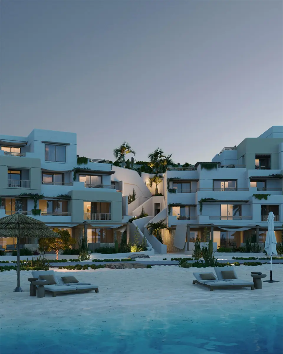 Oyster at Masyaf – Lagoon beach with daybeds and lit terraces at twilight