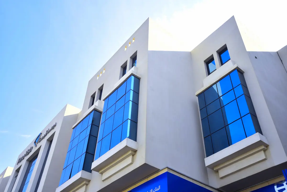 Prima Vista – Medical Office & Commercial Mall – Stepped frames of the projecting glass bays against a clear sky in cooler light