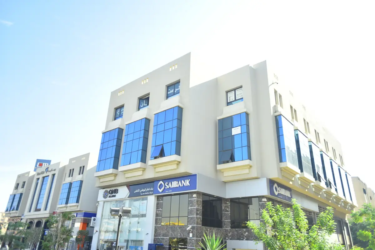 Prima Vista – Medical Office & Commercial Mall – Wider corner view with neighbouring blocks and street trees under a bright sky
