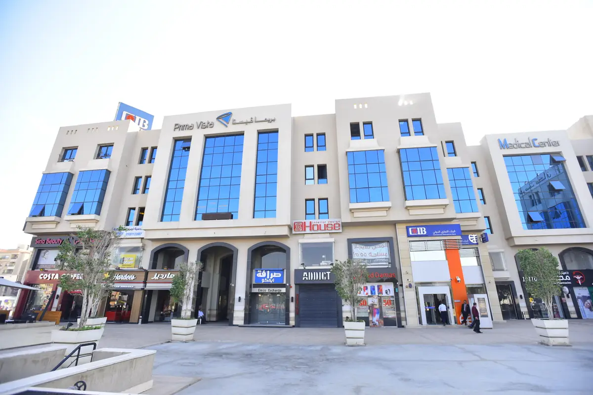 Prima Vista – Medical Office & Commercial Mall – Wide plaza view of the arcaded front with shops, restaurants and potted trees