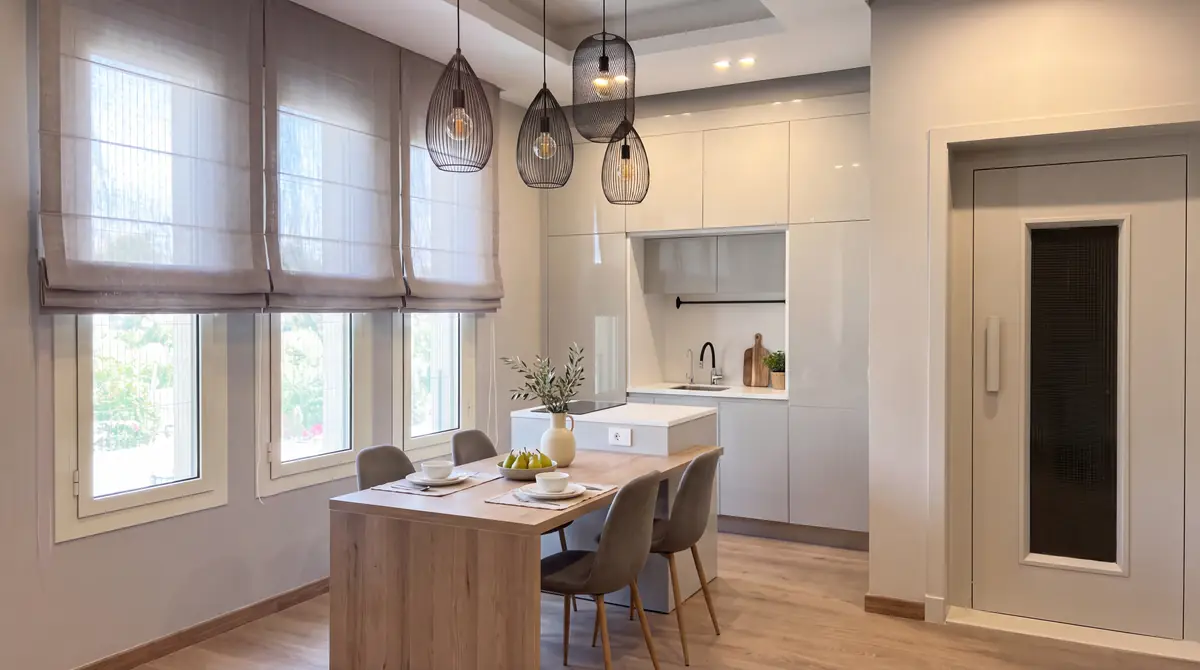 Prof. Dr. M.H. & Prof. Dr. Y.K.'s Villa – Kitchen with light timber table, pendant lamps and white cabinetry